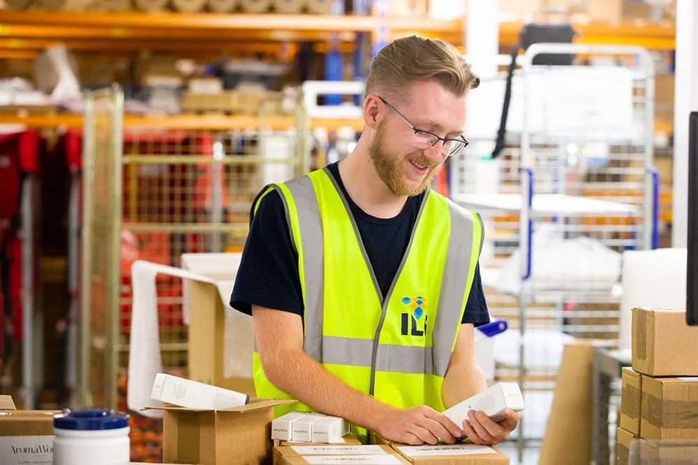 ILG warehouse employee packing boxes