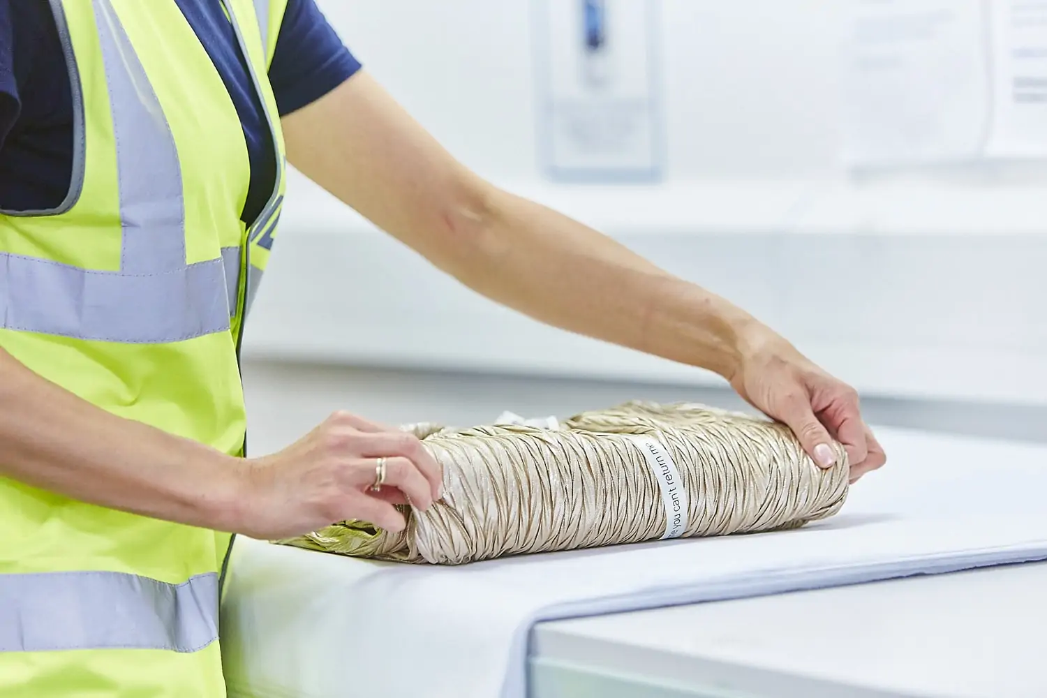 Gift wrapping fulfilment service - a woman carefully wraps an item