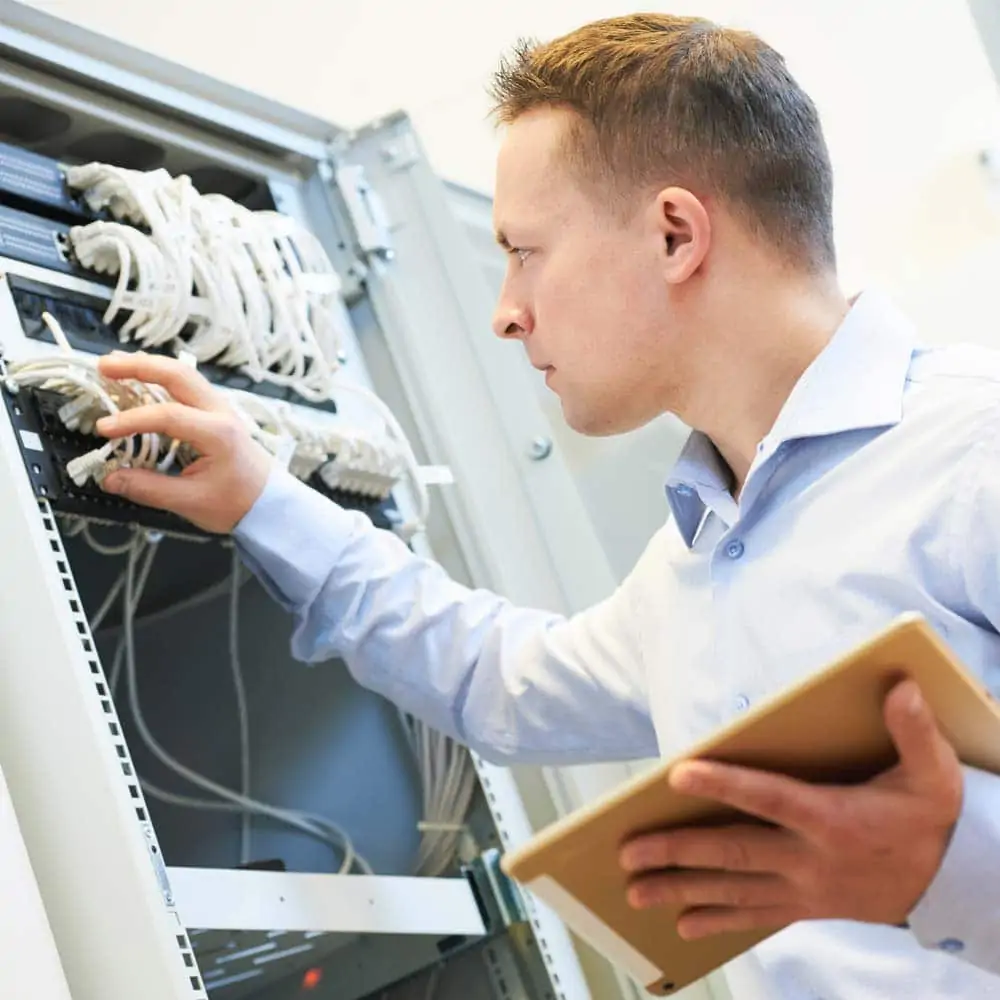 A man inspecting server cables