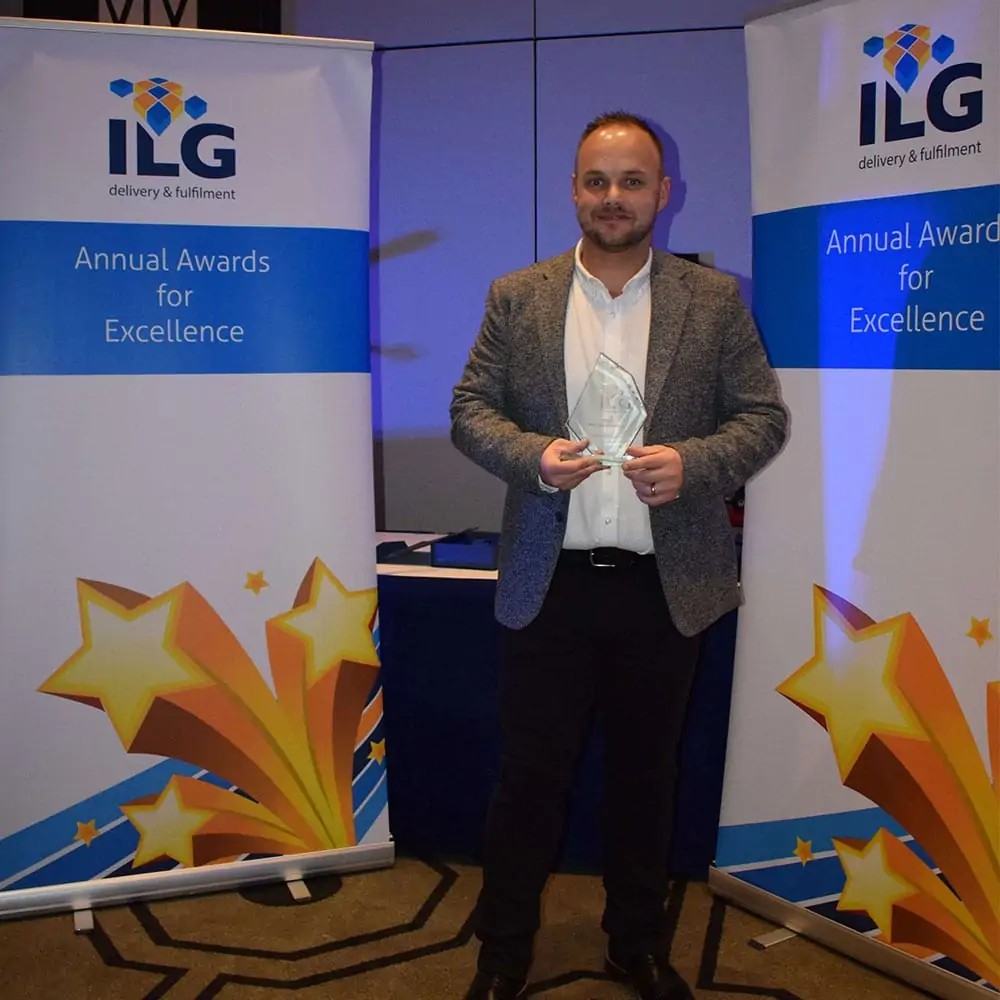 ILG employee accepting award
