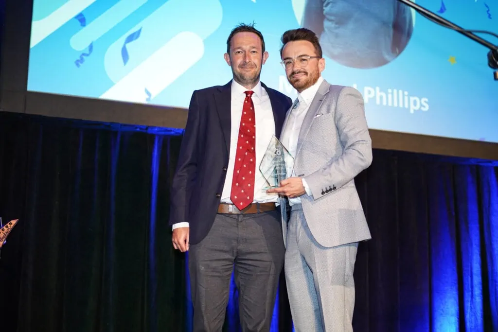 Team members accepting an award on stage