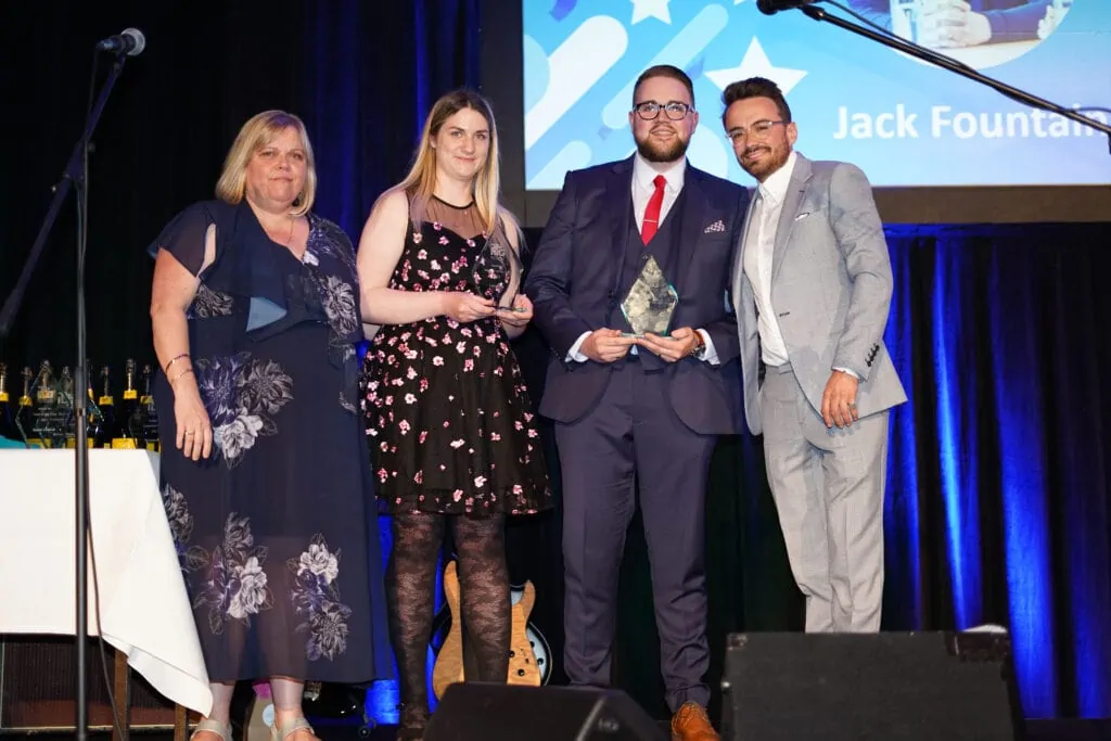 4 team members accepting an award on stage