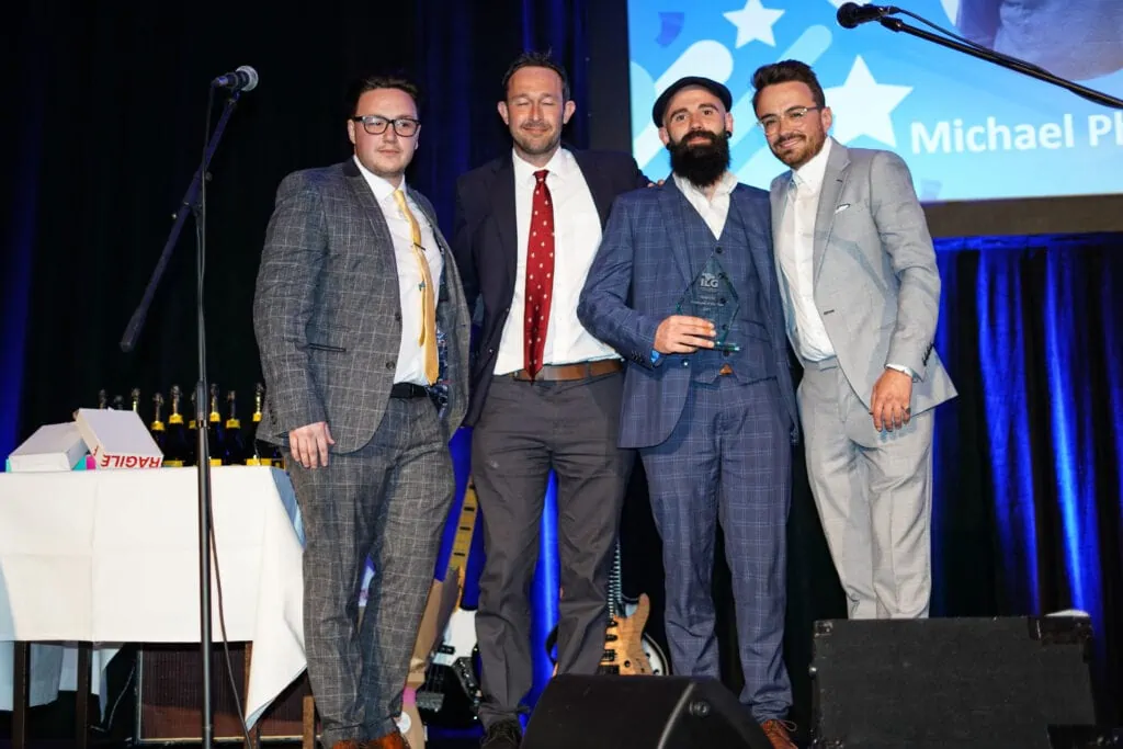 4 team members accepting an award on stage