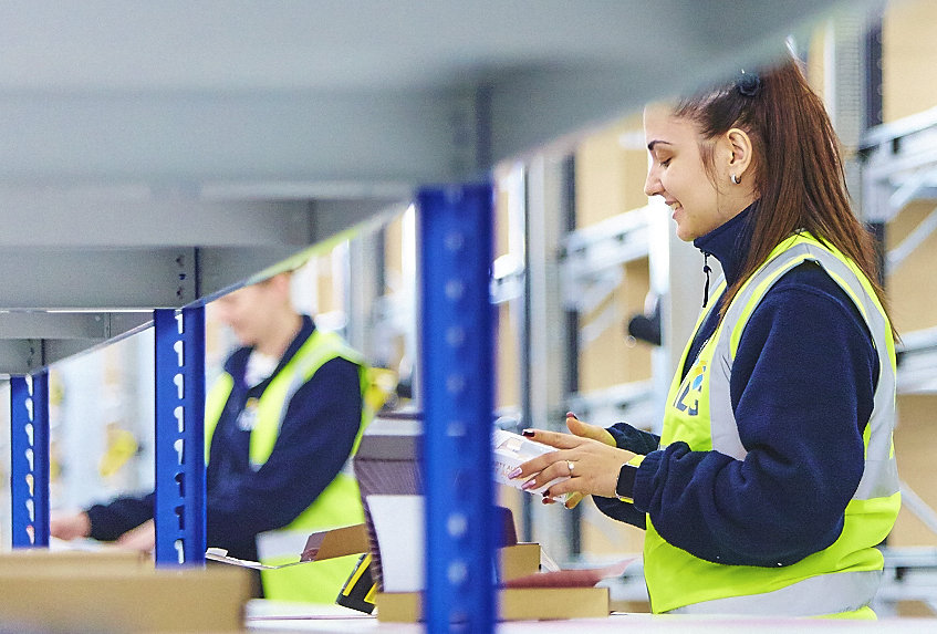 2 ILG warehouse employees packaging orders in a warehouse