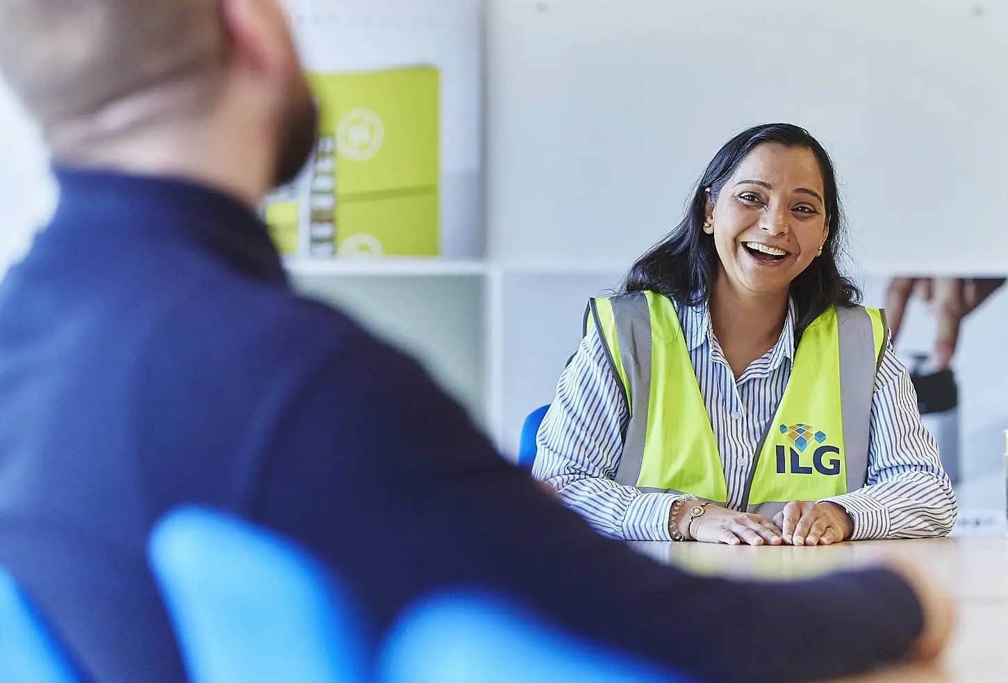Woman in high vis vest laughing