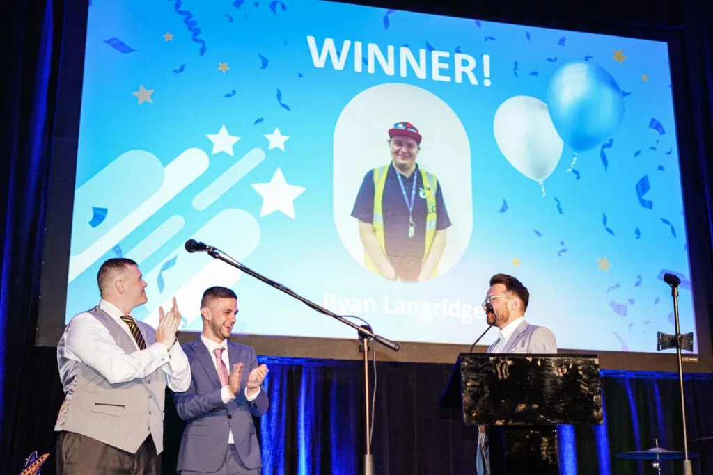People clapping for ILG award winner on stage